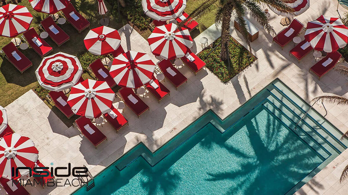 Lush poolside oasis at the Faena Hotel in Mid Beach Miami, showcasing elegant loungers and vibrant tropical foliage.